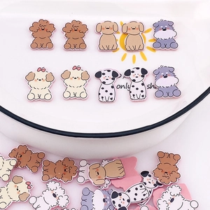 Close-up of cute resin puppy charms including Schnauzer and Poodle for DIY jewelry