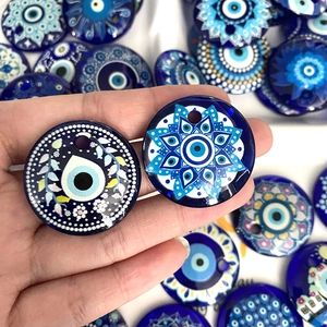 Gros plan de pendentifs Mauvais Oeil en verre bleu avec motifs mandala pour bijoux