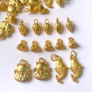 Golden DIY jewelry charms featuring koi fish, lucky cat, and lotus pod for necklaces