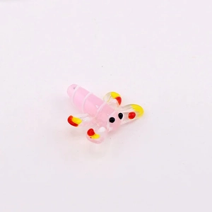 Macro detail of a colorful glass dragonfly bead for DIY jewelry making with spotted wings