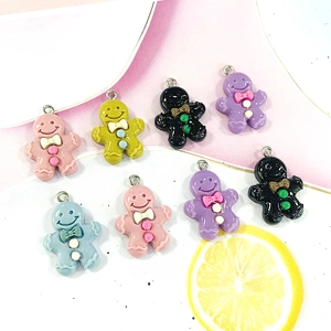 Flat lay of colorful gingerbread man resin charms with metal loops for DIY jewelry making