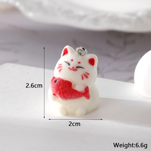 Close-up of a 2.6cm flocked 3D Maneki Neko lucky cat charm holding a red fish