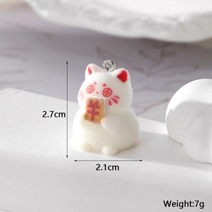 Detailed view of white flocked lucky cat charm with currency symbol and metal ring
