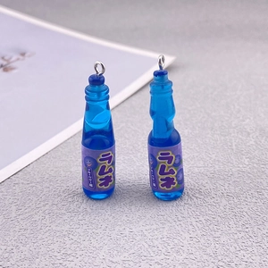 Close-up of blue resin Ramune soda bottle pendants for DIY jewelry and keychain charms