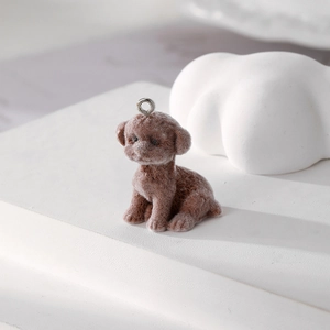 Close-up of a brown flocked teddy dog charm with a silver ring for DIY accessories