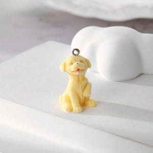Macro shot of yellow flocked puppy pendant with metal ring for DIY jewelry making