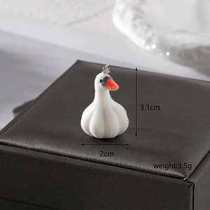 Macro shot of white flocked swan pendant with dimensions 3.1cm and silver ring attachment