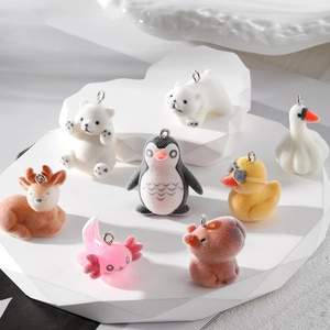 Set of eight assorted flocked animal charms including capybara and penguin for DIY crafts