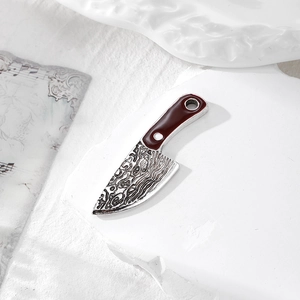 Macro detail of alloy chef knife pendant with damascus pattern and dark red handle