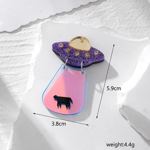 Detailed view of iridescent acrylic UFO and cow pendant with size and weight dimensions