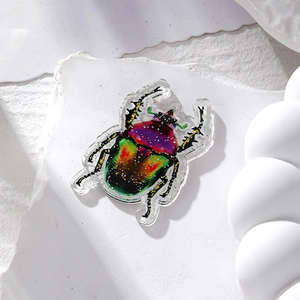 Close-up of acrylic ladybug pendants with colorful glitter finish for DIY jewelry
