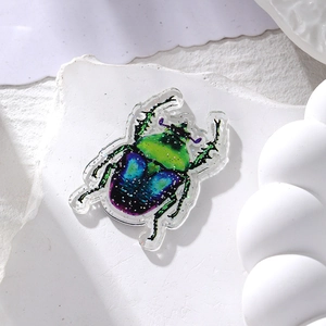 Macro view of colorful glitter ladybug pendant made of acrylic for DIY jewelry making