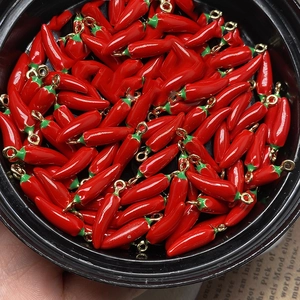 DIY jewelry charms featuring red chili pepper pendants with golden metal hanging rings