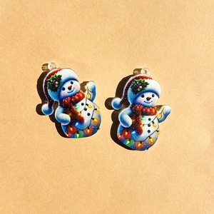 Pair of acrylic snowman pendants with blue hats and red scarves for holiday DIY crafts