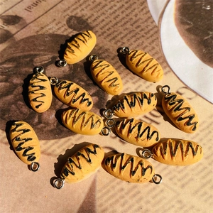 Detailed view of handmade resin bread charms with silver rings for DIY jewelry making