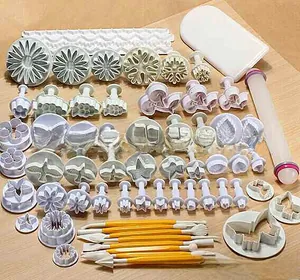 Macro view of a 14-piece DIY baking set featuring various fondant plungers and embossers