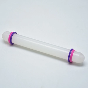 Detailed view of 23cm non-stick white rolling pin with purple and pink guide rings