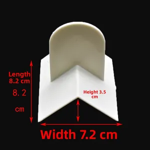 White plastic L-shaped corner positioner with a semi-circle handle on black background