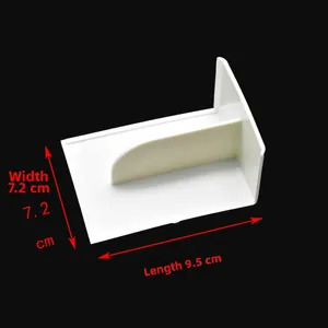 Macro detail of white plastic cake scraper showing dimensions 9.5cm length and 7.2cm width