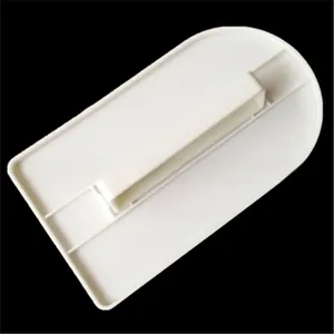 White rectangular cake scraper with ergonomic handle for smooth cream leveling