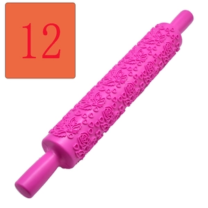 Detail showing pink fondant embossing rolling pin with floral and heart patterns