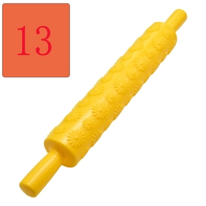 Detail of yellow flower-patterned rolling pin for embossed fondant and pastry dough