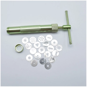 Detail of green stainless steel clay extruder with 20 interchangeable pattern discs