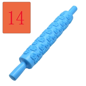 Detail of blue fondant rolling pin featuring rose flower embossed texture for DIY baking