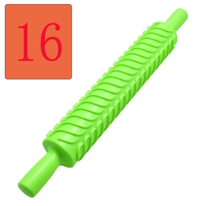 Macro shot of green wavy pattern texture on a plastic fondant embossing rolling pin