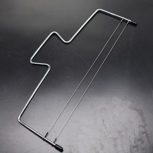 Macro detail of adjustable double stainless steel wires on a professional cake leveler