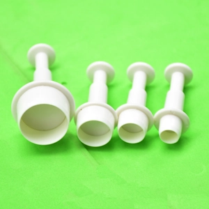 Detail of 4pcs white spring-loaded round plunger cutters for fondant and cookie dough