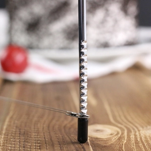 Detailed macro shot of stainless steel cake slicer pillar with adjustable notches