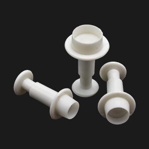 Set of 3 white geometric plunger cutters for fondant and cookies on a black background