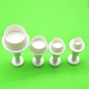 Set of four white plastic round plunger cutters for fondant and cookie dough shaping