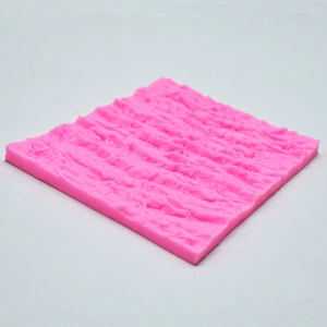 Detailed macro view of pink silicone mold featuring natural rock and bark texture