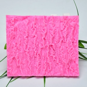 Detailed macro view of pink silicone mold featuring realistic tree bark texture for DIY cake