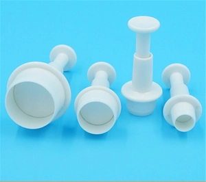 Detail of 4-piece white plastic round plunger cutters for fondant and cookie dough