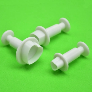 Three-piece set of white spring-loaded round fondant plunger cutters for cake decorating