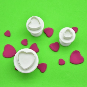 Detailed set of three heart-shaped spring plunger cutters for fondant and cookie baking