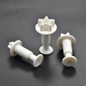 Close-up of 3-piece white star plunger cutters for fondant and cookie dough DIY