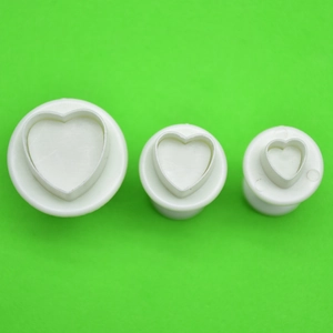 Three-piece heart-shaped plunger cutters for fondant and cookie dough embossing