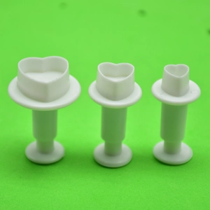 Detail view of three heart-shaped plunger cutters for fondant and cookie dough baking