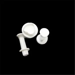 Detailed view of white plastic spring-loaded fondant plunger cutters with heart shape