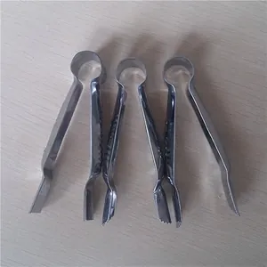 Set of three stainless steel kitchen tweezers with non-slip grip on wood background