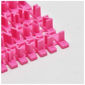 Macro shot of pink plastic DIY cookie stamp set with interchangeable letters and symbols