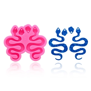 Pink snake silicone mold with blue glitter resin finished product on white background