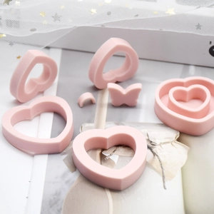 Pink silicone mold detail featuring heart shapes and butterflies for candle making