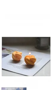 Detailed view of handmade knot-shaped orange candles made from heat-resistant silicone mold