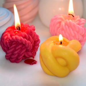 Creative knot and wool ball candles in vibrant pink and yellow colors for home decor
