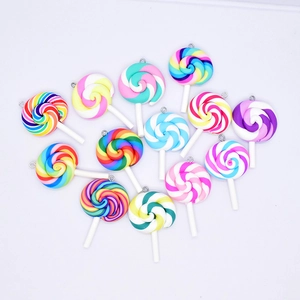 Detailed close-up of various colorful resin lollipop charms with metal rings for DIY
